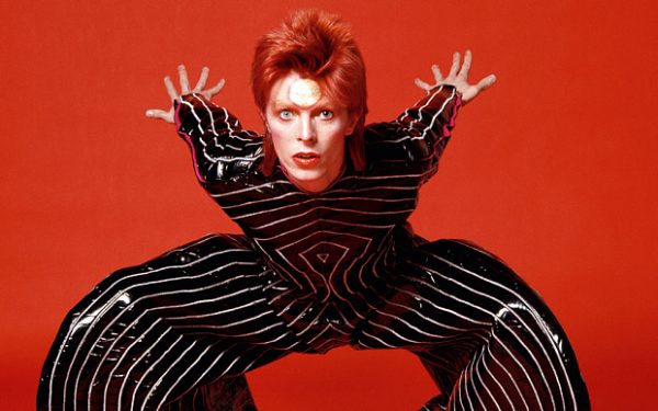 CAPTION / STORY MUST CONTAIN THE FOLLOWING: Bowie: Album by Album, published by Carlton, £25, available to buy online and from all good bookstores. No payment required for usage on 12/11/2012. Image must only be published in connection with the release of the book Bowie: Album by Album. Picture shows: David Bowie crouching in his overalls from the session with Masayoshi Sukita at RCA. The outfit is by the renowned Japanese designer Kansai Yamamoto, whom Bowie had met through Sukita and who went on to design many of Ziggy's most flamboyant costumes. 1973rca-009.jpg